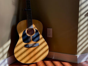 Guitar in a corner of a house